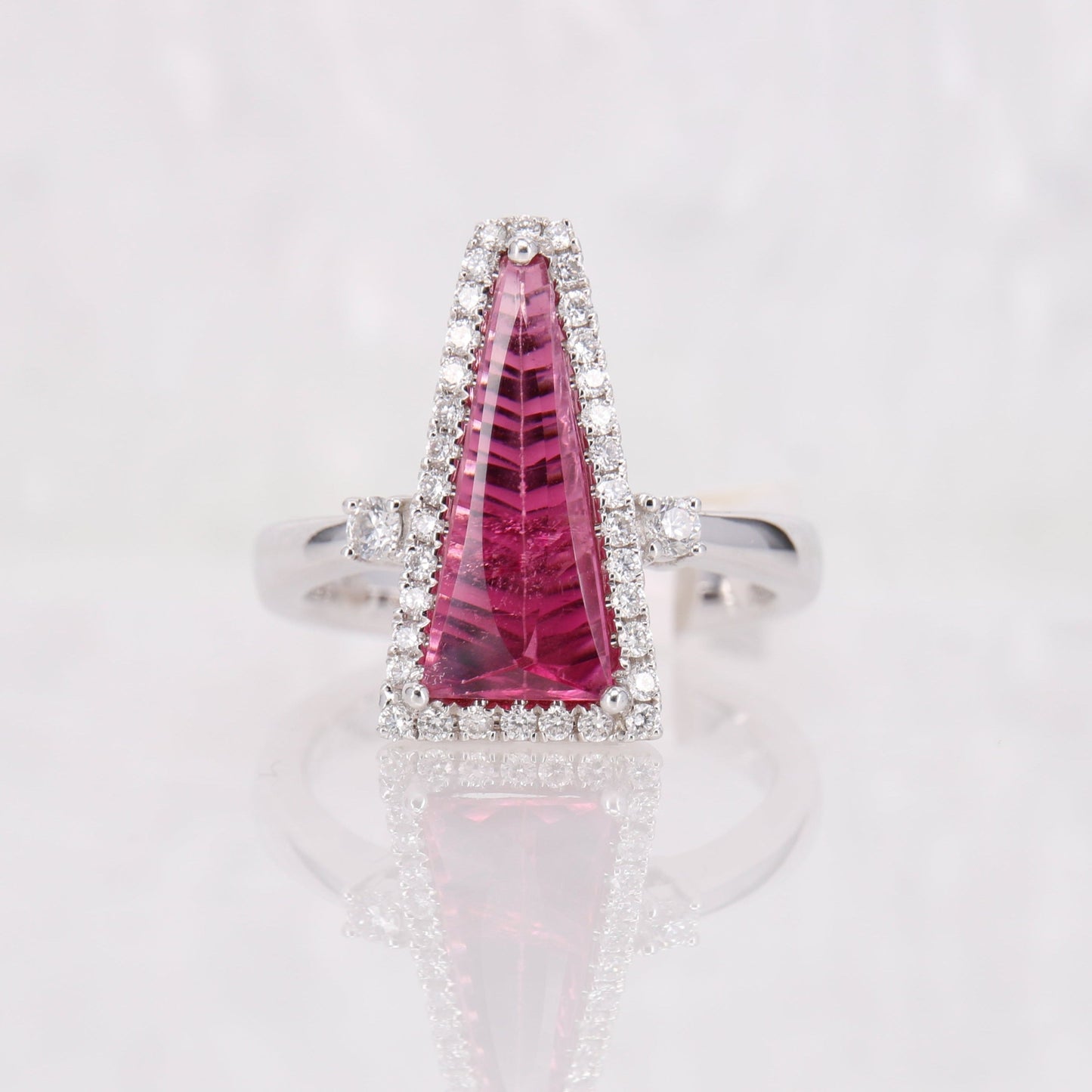 18ct white gold pink tourmaline and diamond ring. Faceted bright pink tourmaline and diamond ring. 
