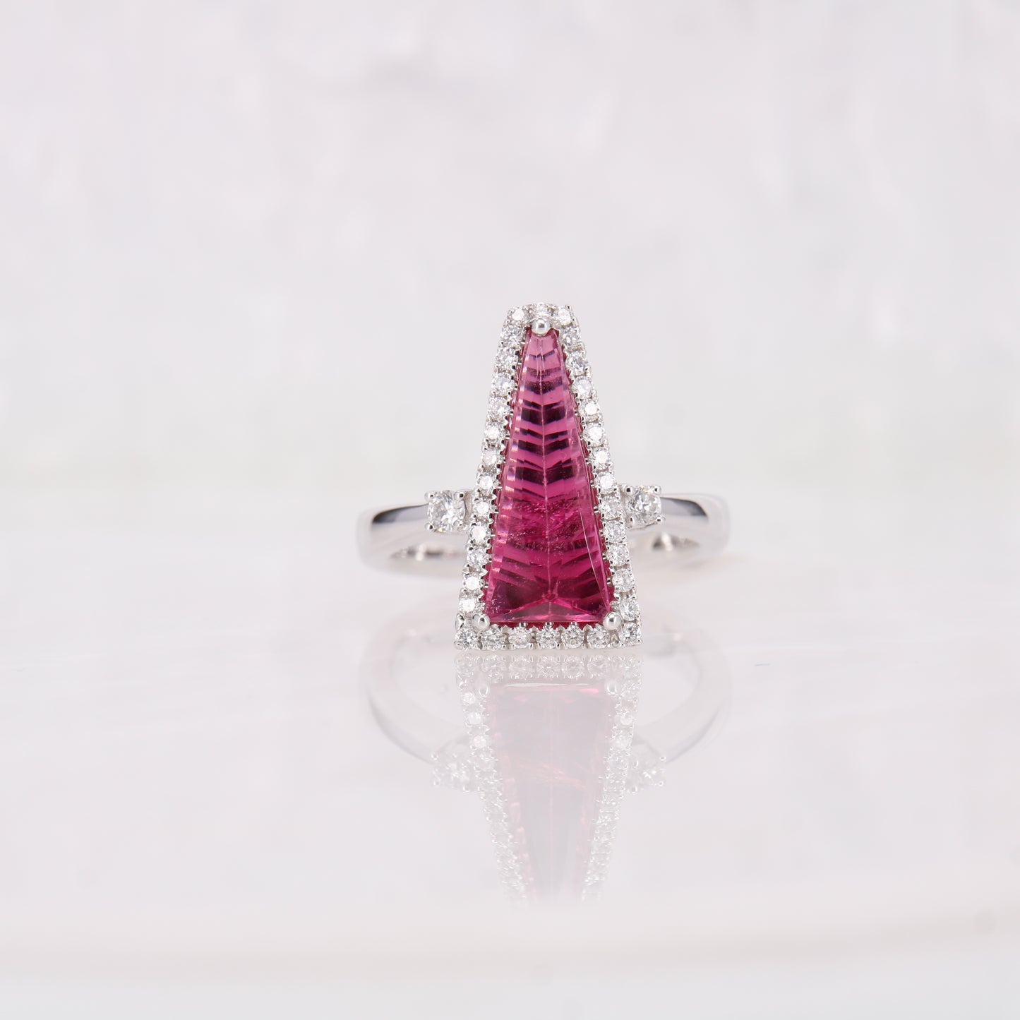 18ct white gold pink tourmaline and diamond ring. Faceted bright pink tourmaline and diamond ring.