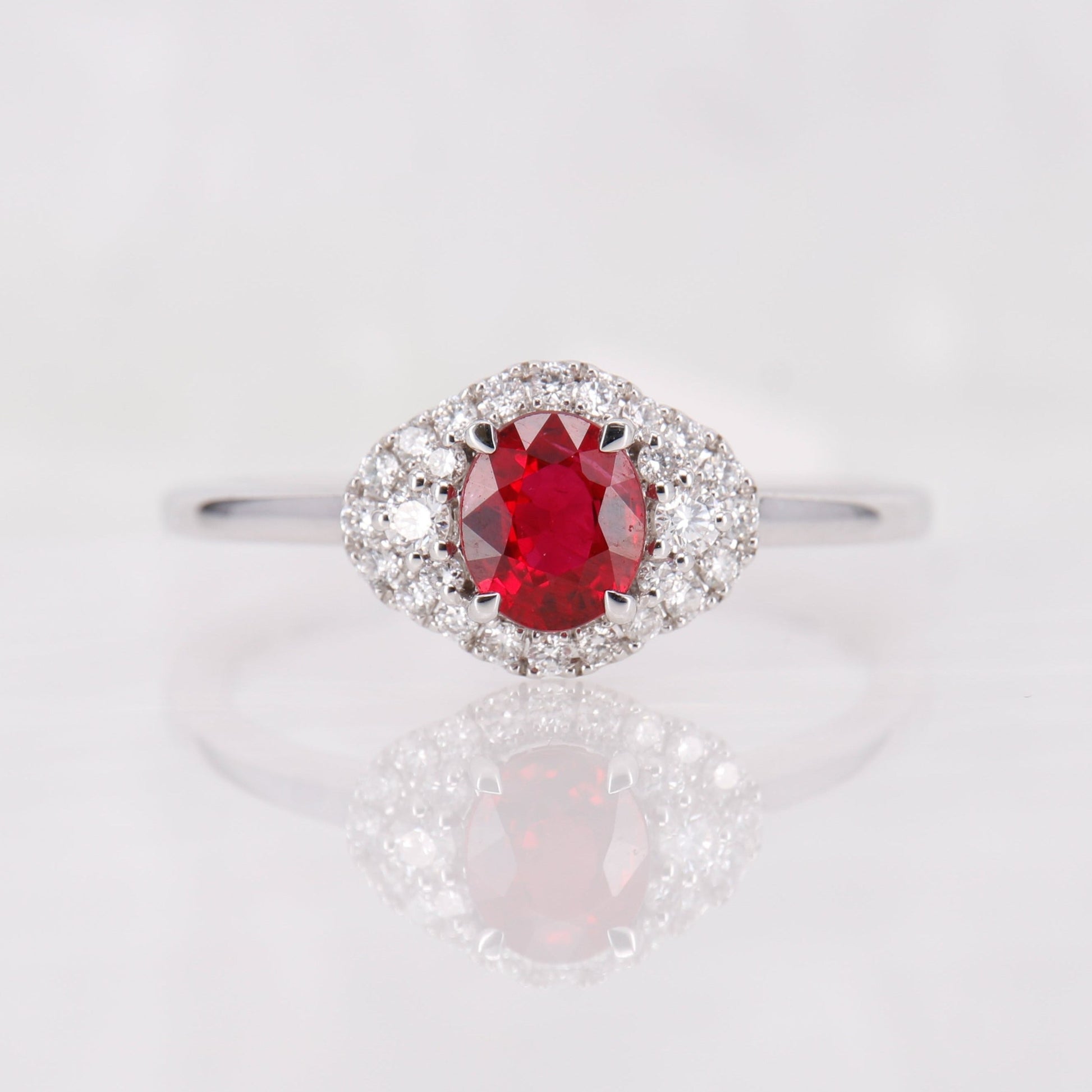 18ct White Gold oval cut Ruby and diamond halo ring. 