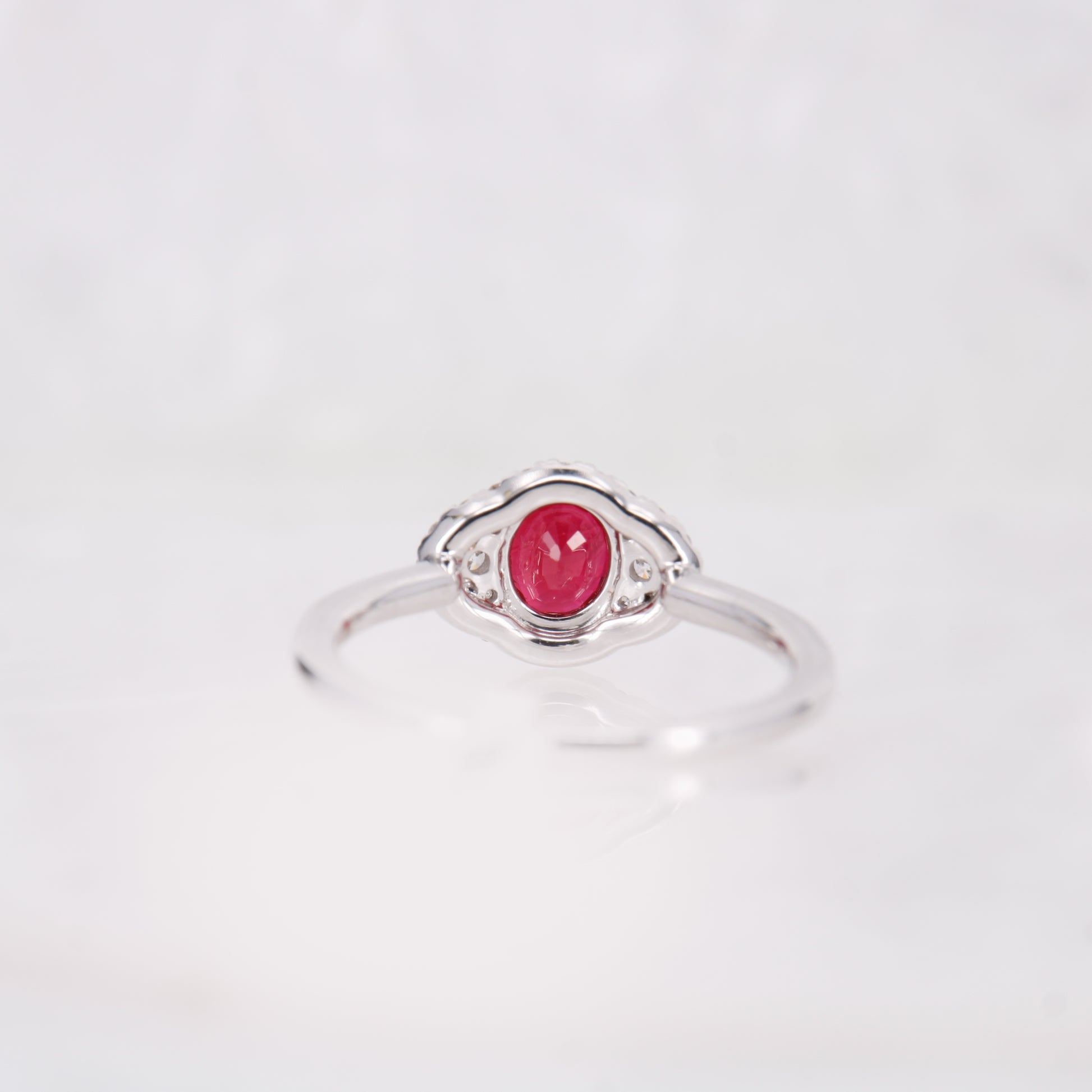 18ct White Gold oval cut Ruby and diamond halo ring. 