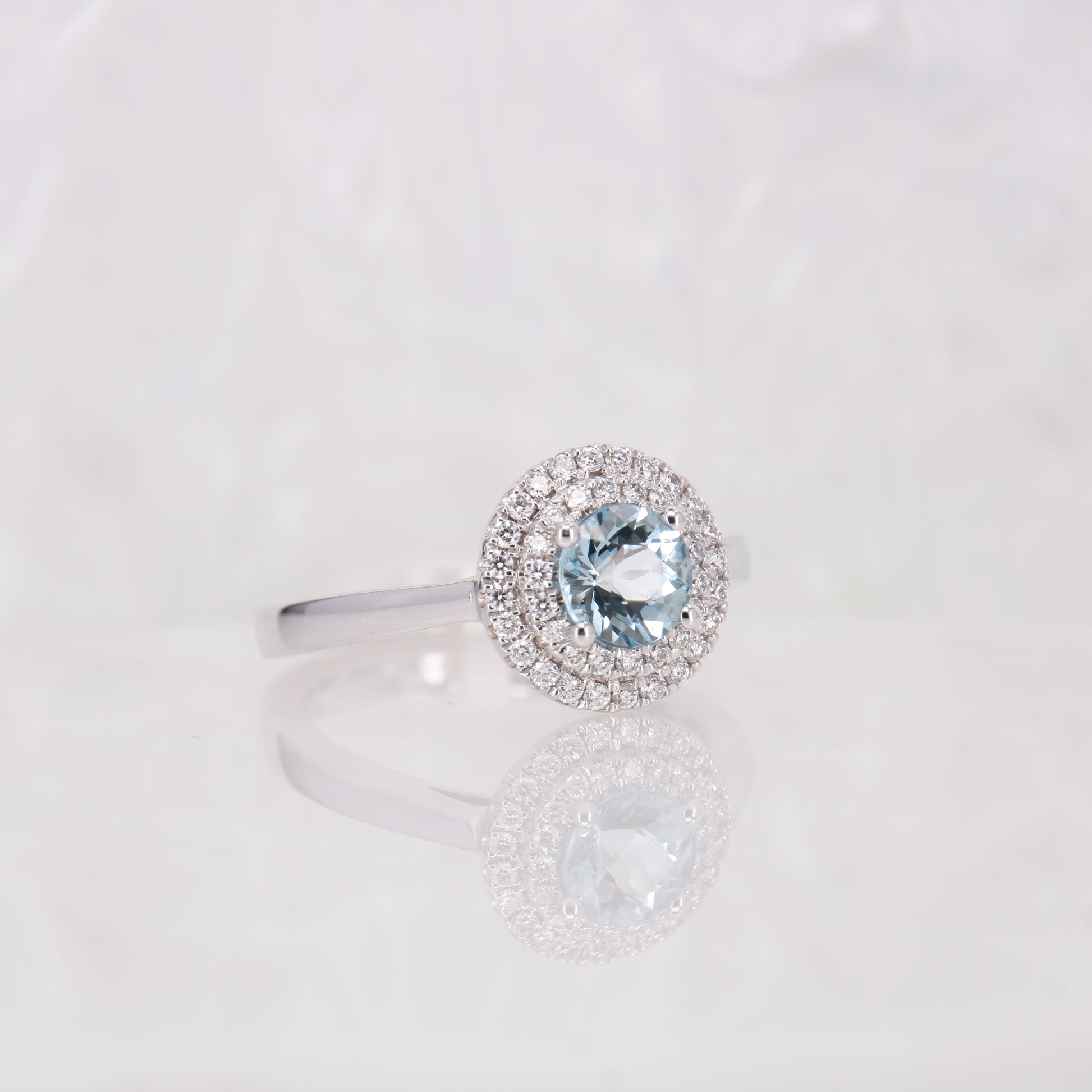 18ct White Gold Aquamarine and Diamond Ring. 0.78ct aquamarine and a double halo of diamonds. 