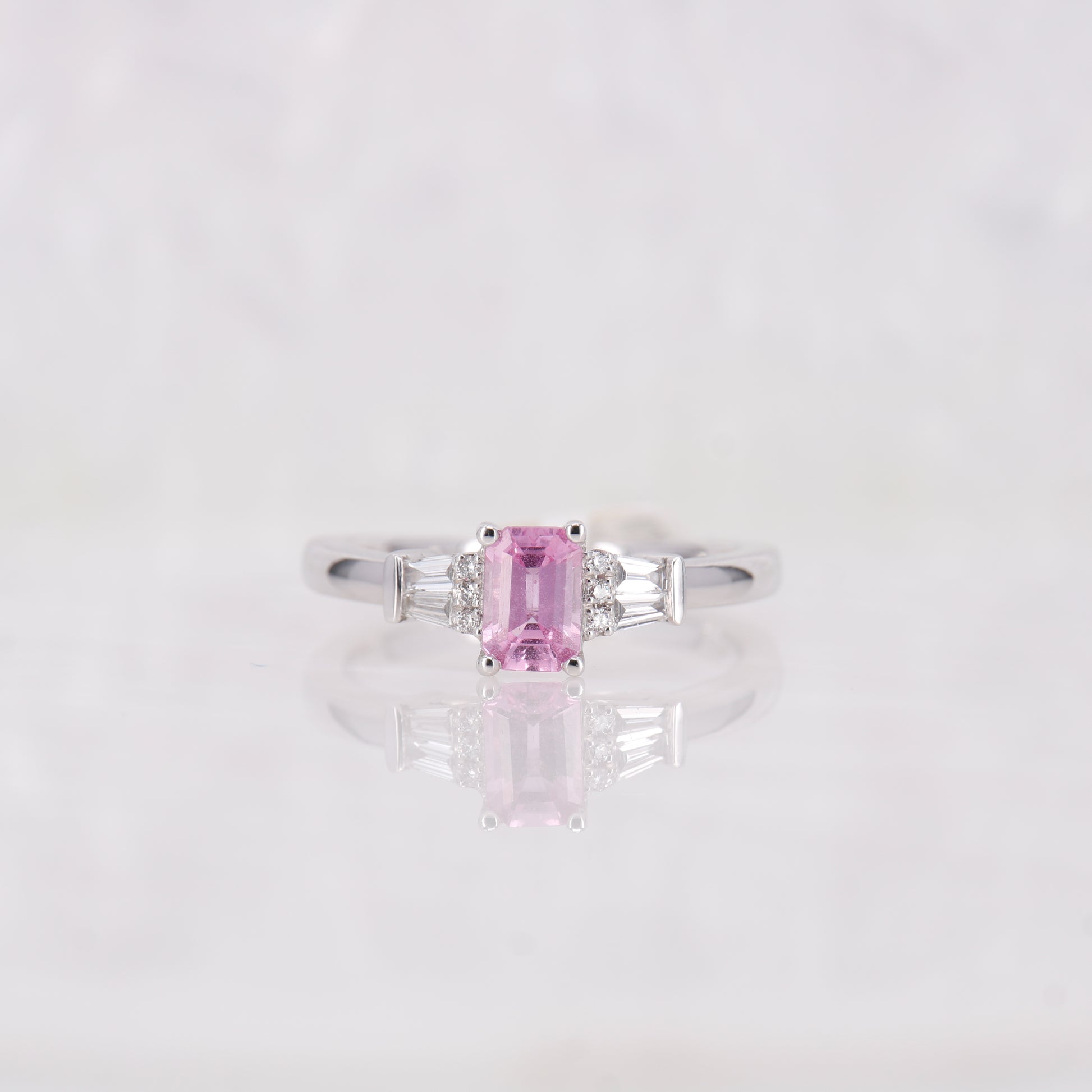 Pink Sapphire and Diamond Ring set in Platinum. Tapered baguette side stones.