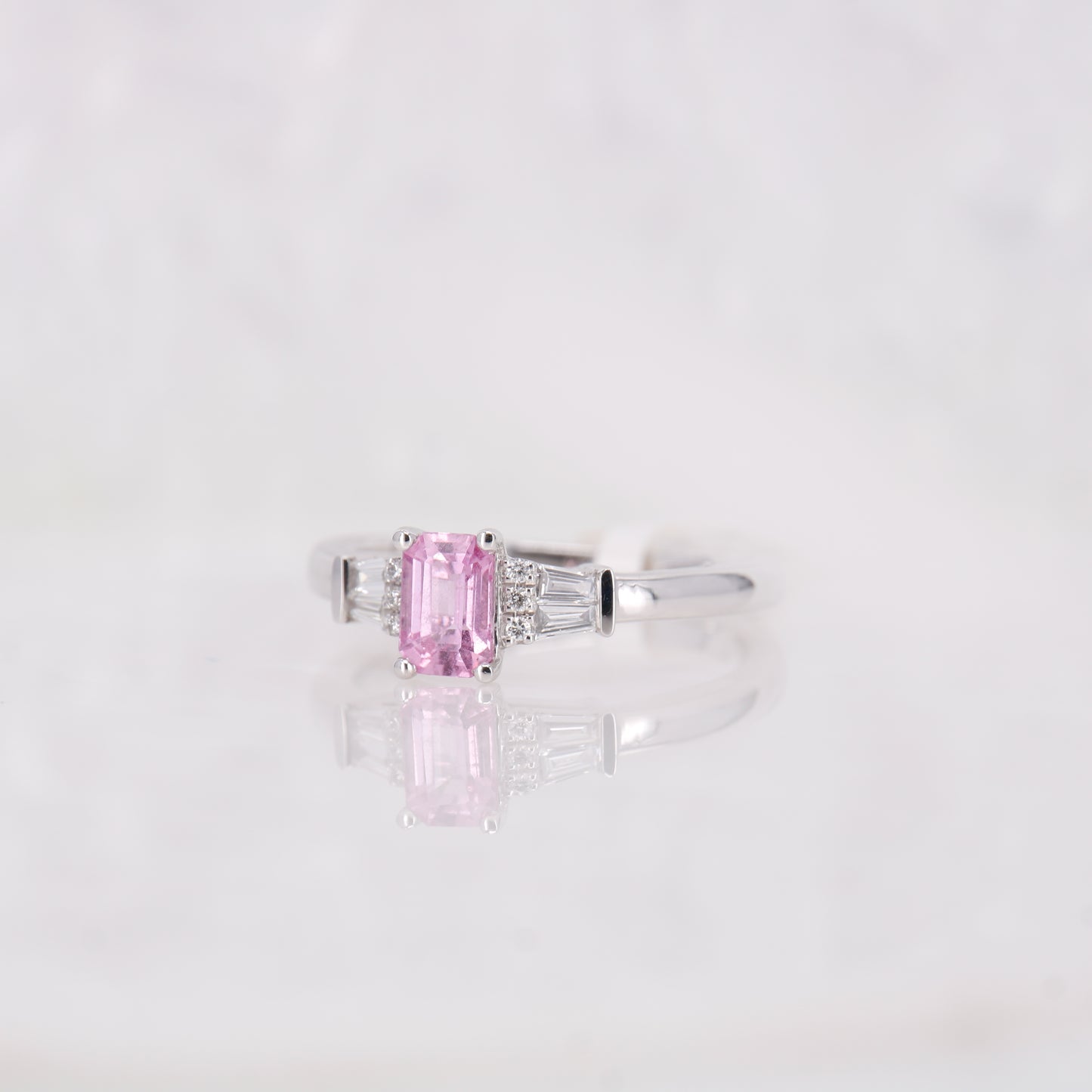 Pink Sapphire and Diamond Ring set in Platinum. Tapered baguette side stones.