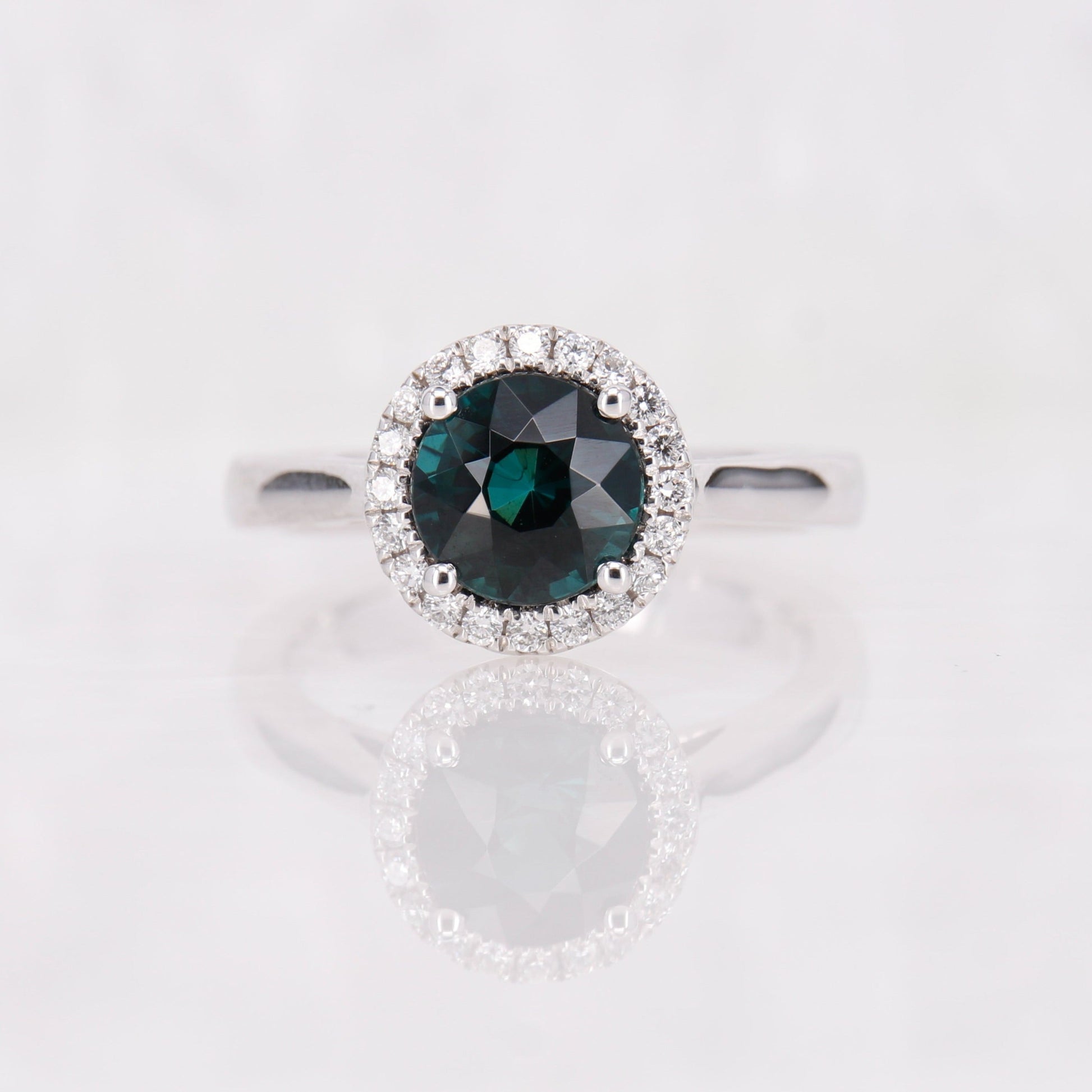 Blue tourmaline and diamond halo ring set in 18ct white gold. 