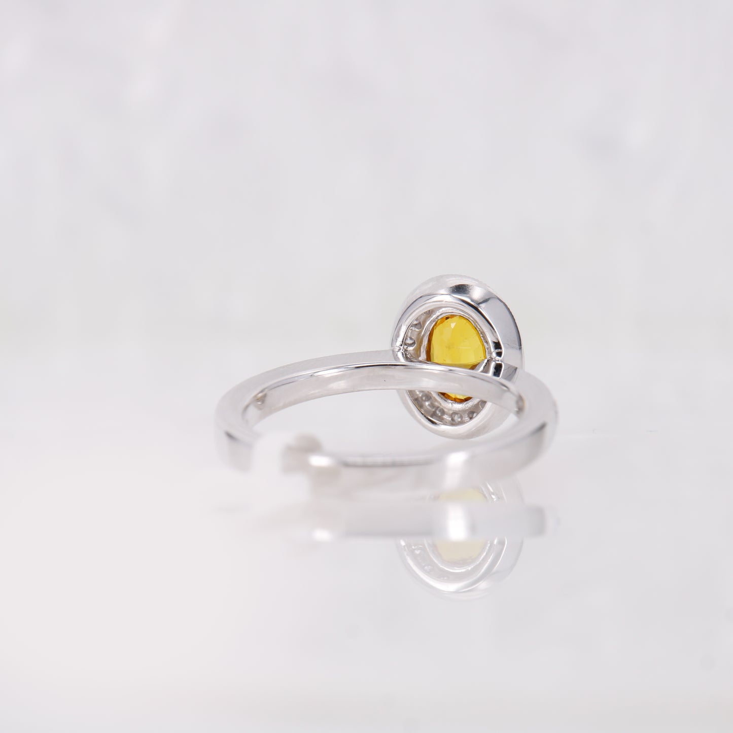 Yellow Sapphire oval engagement ring. Yellow orange sapphire surrounded by a halo of diamonds. 