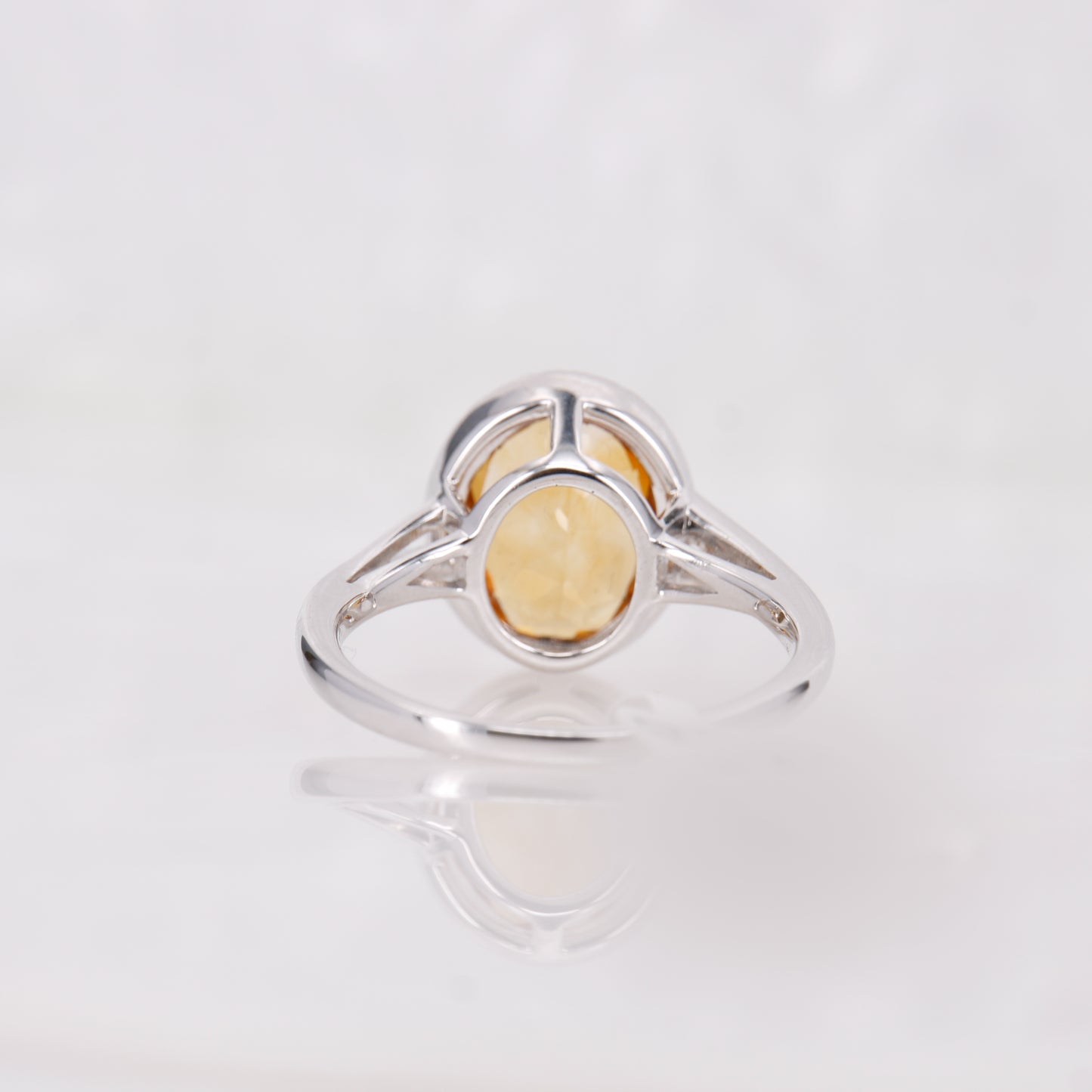 Citrine and Diamond ring set in 18ct white Gold. Oval cut citrine with a halo of diamonds 