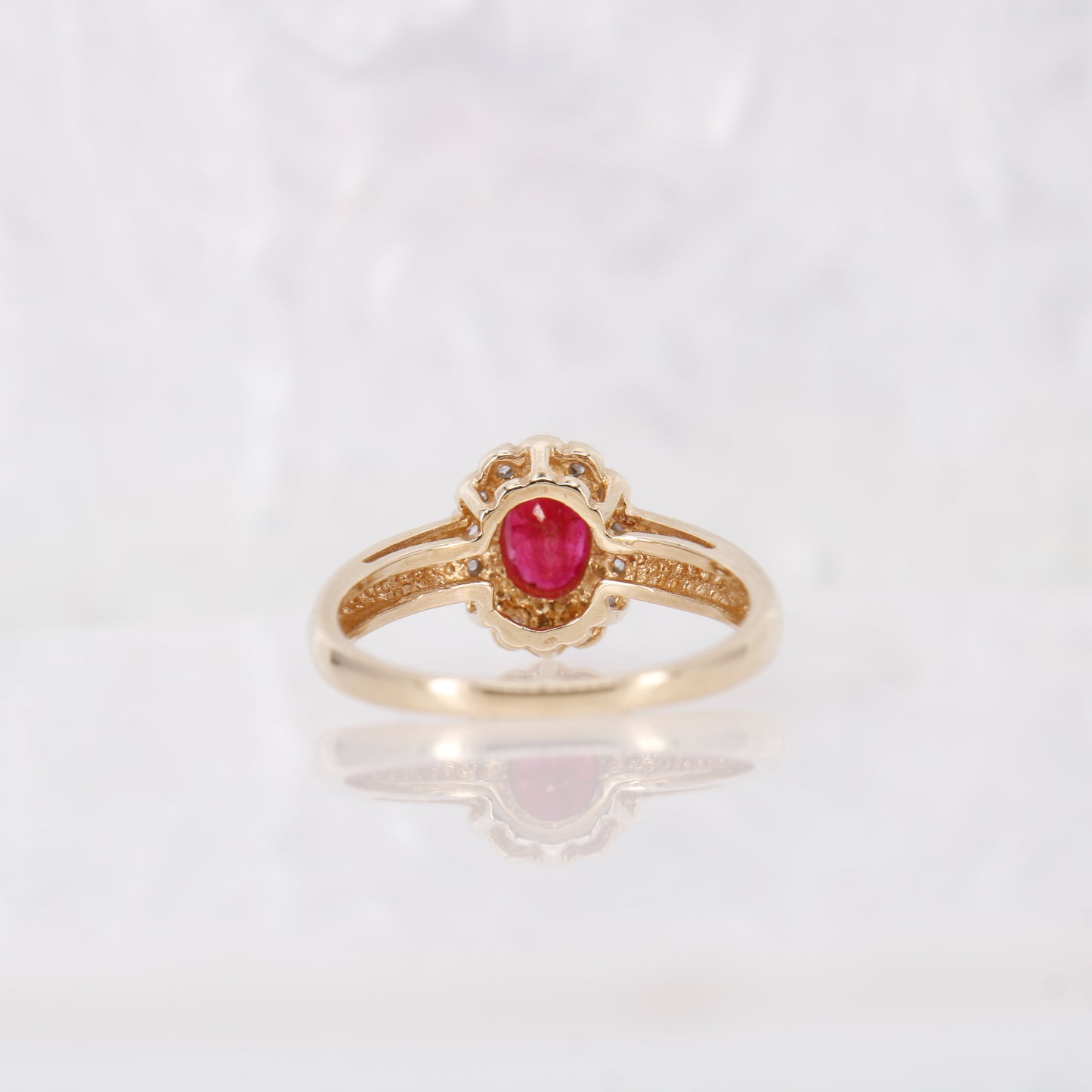 Secondhand Vintage Garnet and Ring. Halo cut Garnet with a halo of diamonds, set in 9ct gold.