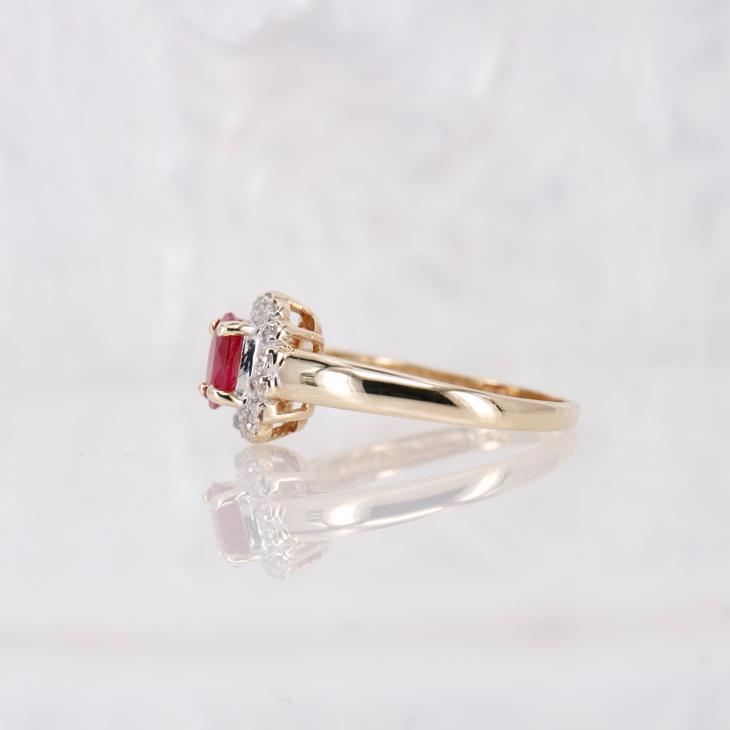 Secondhand Vintage Garnet and Ring. Halo cut Garnet with a halo of diamonds, set in 9ct gold.