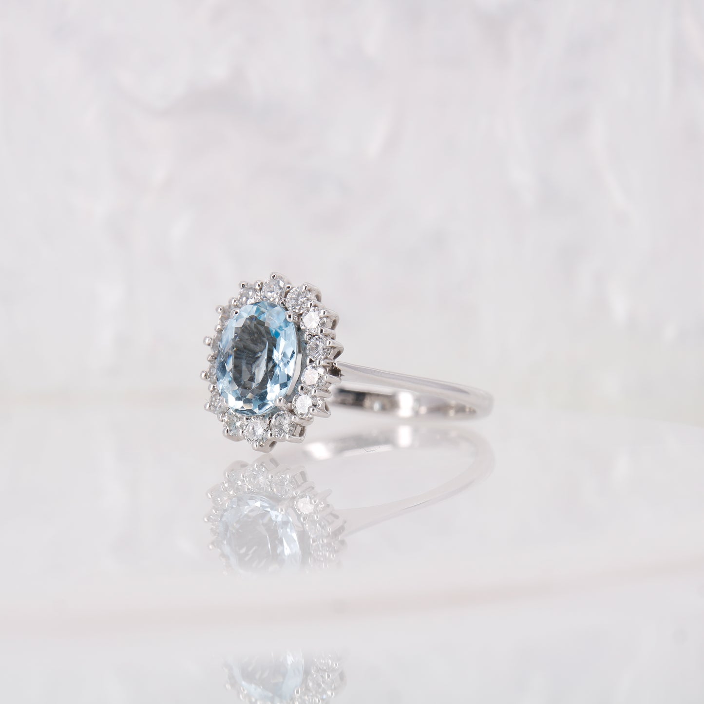 Vintage Secondhand Aquamarine and Diamond Engagement Ring 18ct white gold oval cut aquamarine with a halo of diamonds