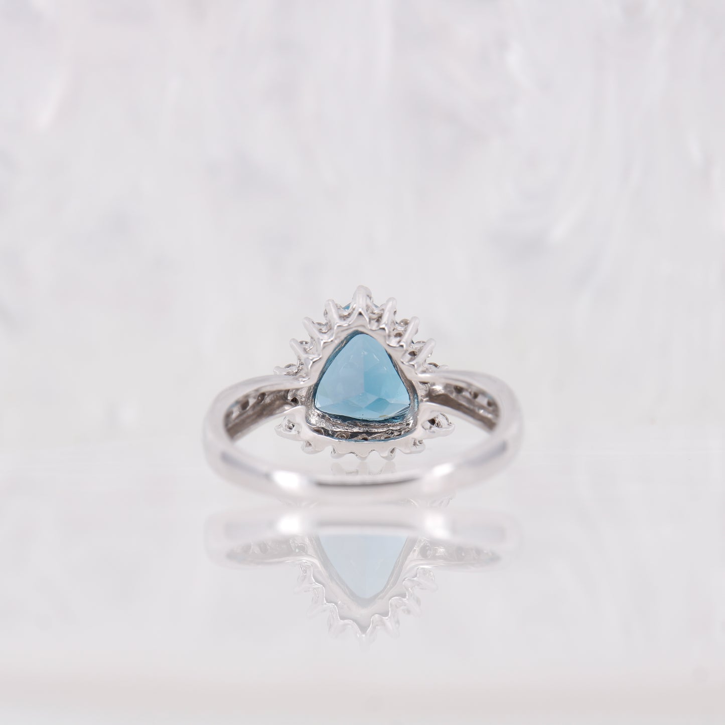 Blue Topaz and Diamond ring, Trilliant cut blue topaz with a halo of diamonds, white gold.