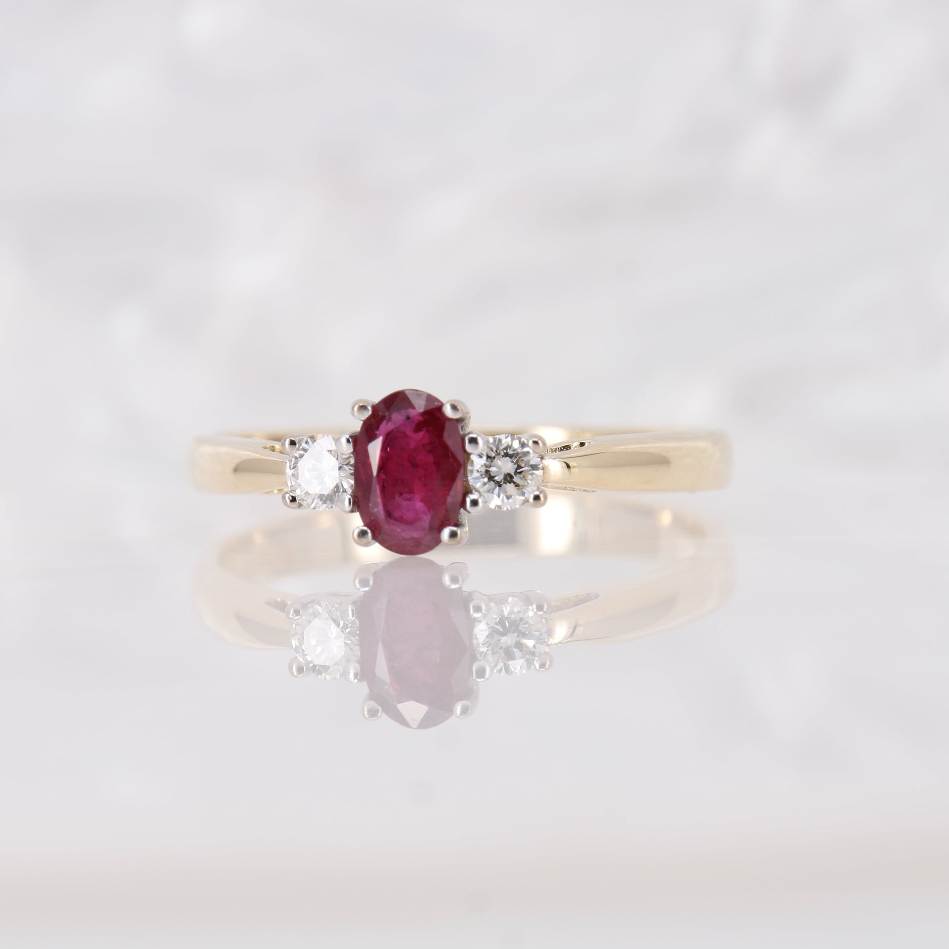 Oval cut Ruby and Diamond Trilogy Three Stone Engagement Ring