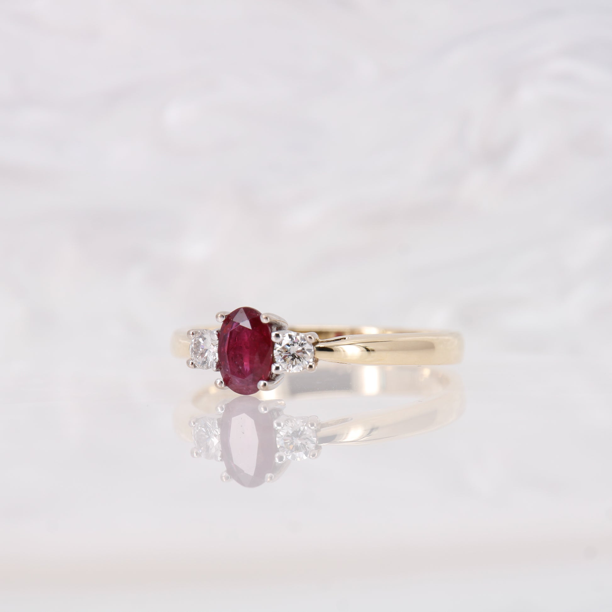 Oval cut Ruby and Diamond Trilogy Three Stone Engagement Ring