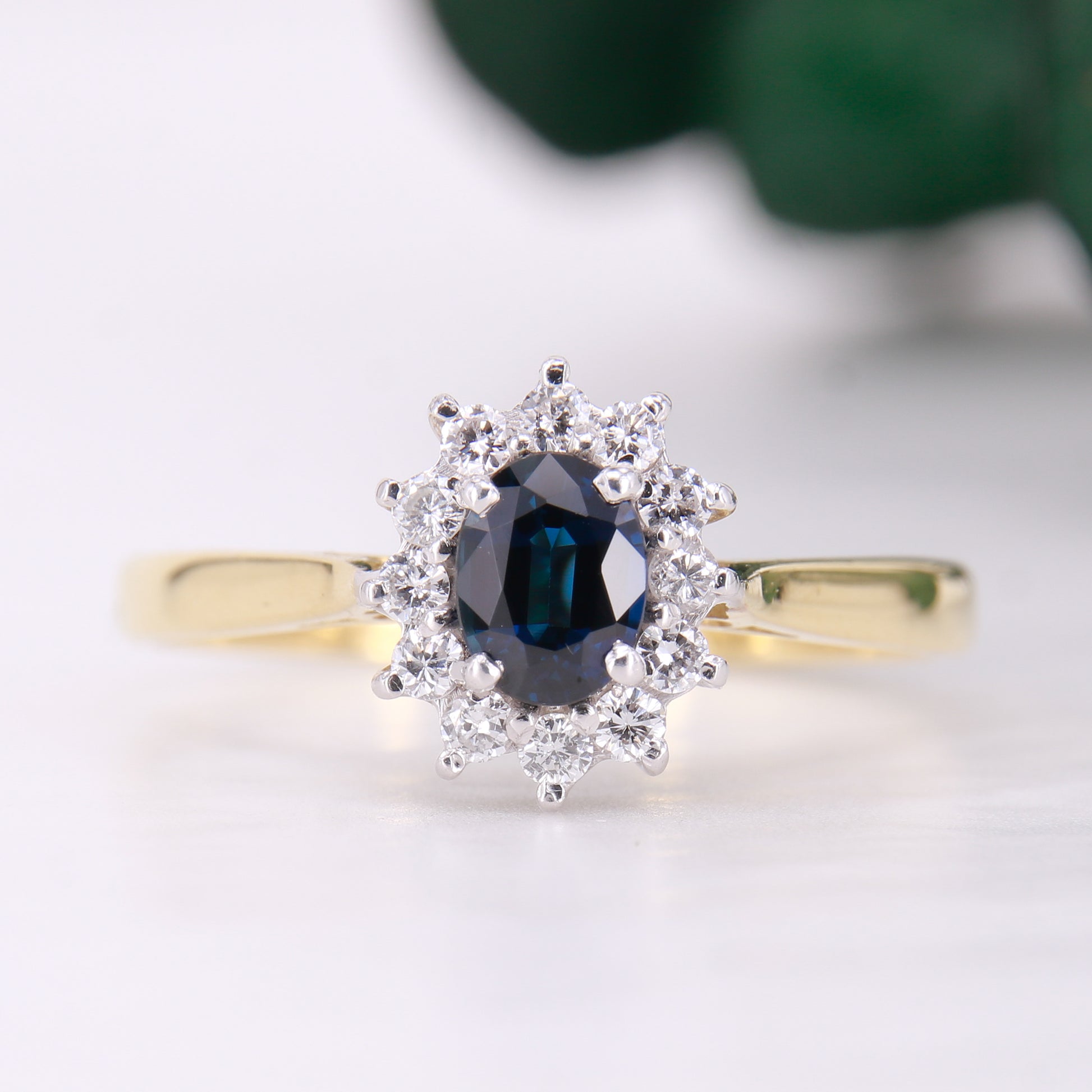 Preowned 18ct yellow gold oval cut sapphire and diamond vintage cluster ring.