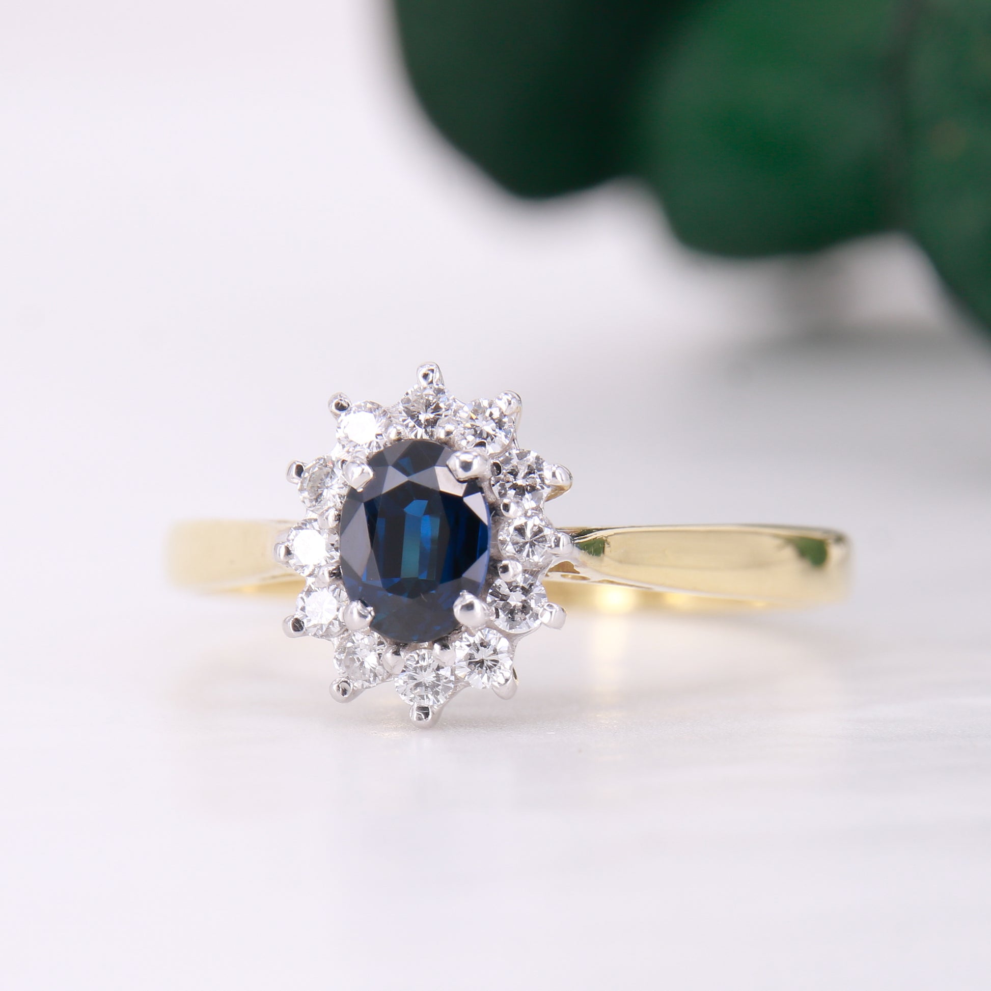 Preowned 18ct yellow gold oval cut sapphire and diamond vintage cluster ring.