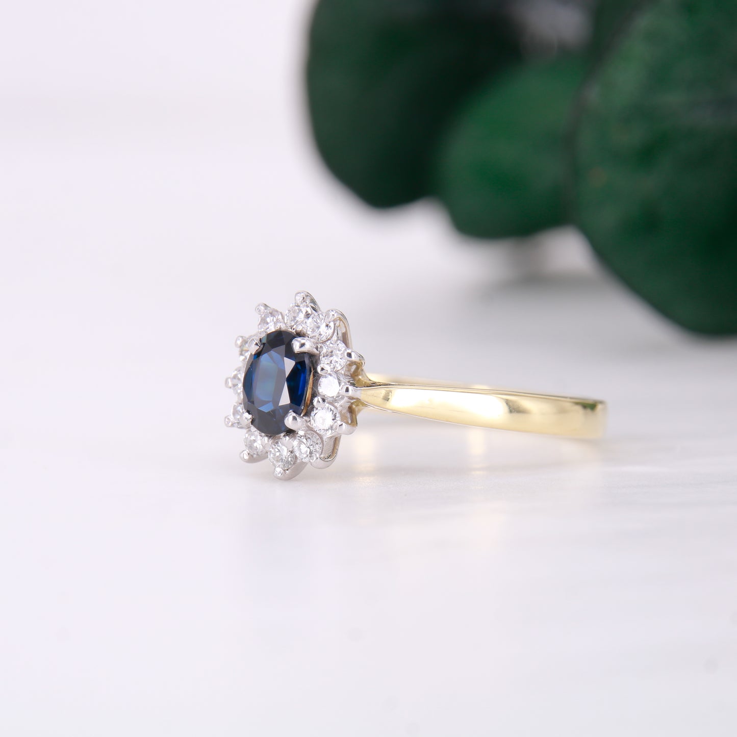 Preowned 18ct yellow gold oval cut sapphire and diamond vintage cluster ring.