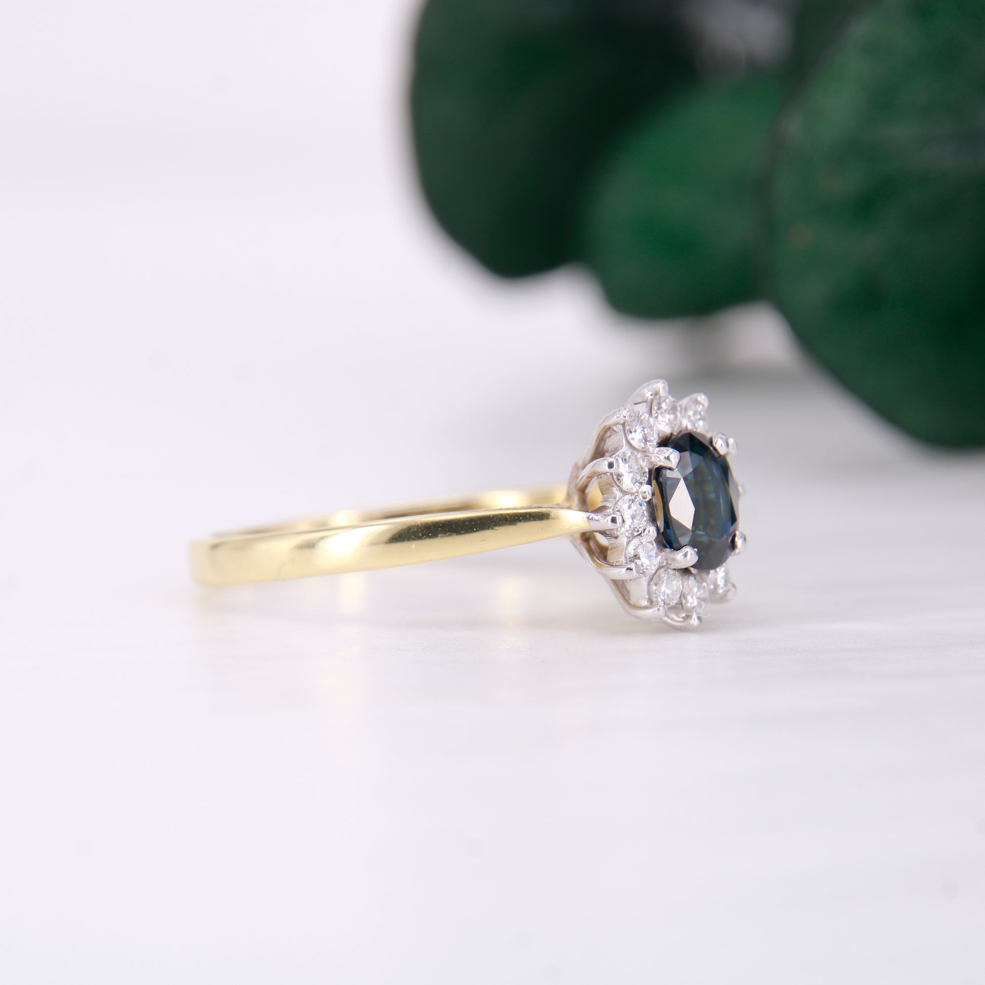 Preowned 18ct yellow gold oval cut sapphire and diamond vintage cluster ring.