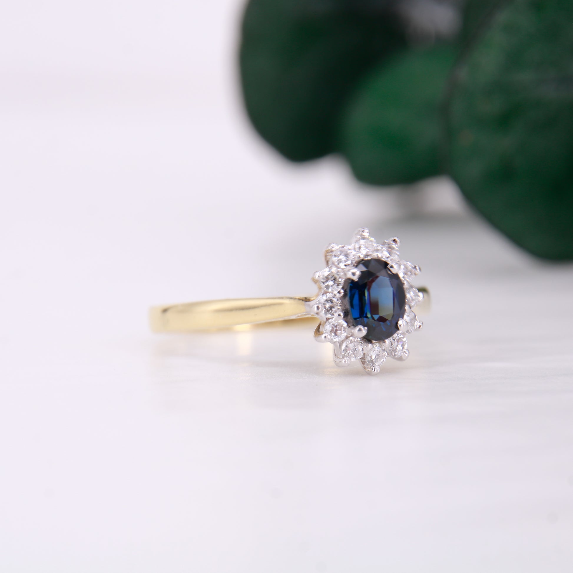 Preowned 18ct yellow gold oval cut sapphire and diamond vintage cluster ring.