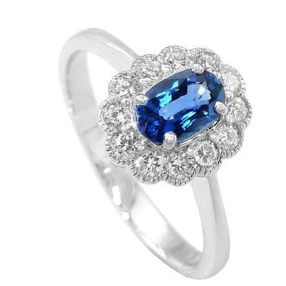 Milgrain edge sapphire and diamond oval cut engagement ring. 