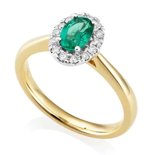 Oval cut emerald and diamond halo ring. Oval cut centre diamond halo 18ct yellow gold