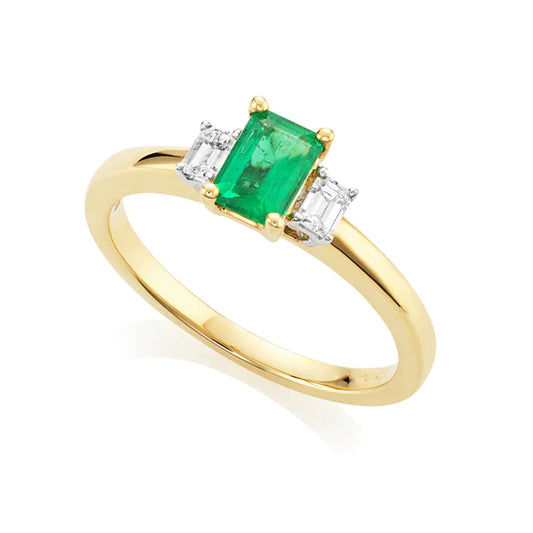 18ct Yellow Gold Emerald and Diamond Trilogy Ring – a timeless embodiment of elegance and sophistication. The star of the show is a dazzling 0.53-carat emerald-cut emerald. Flanked by two exquisite emerald-cut diamonds totalling 0.18 carats